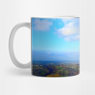 View from above on a hilly landscape under the blue sky with clouds Mug